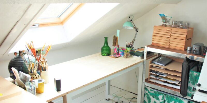 green glass bottle on white wooden desk